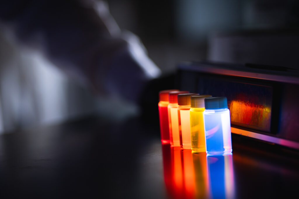 Quantum dots glowing with various colors in vials. Courtesy of UbiQD, Inc.